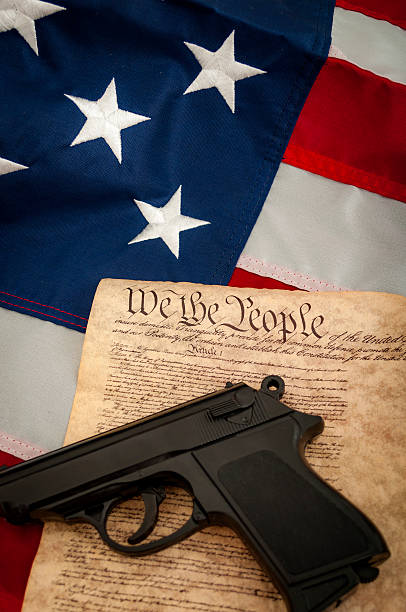 istock American flag, a gun and the US constitution 539356580