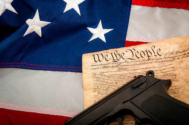 istock American Flag, a handgun and the US constitution 539357008