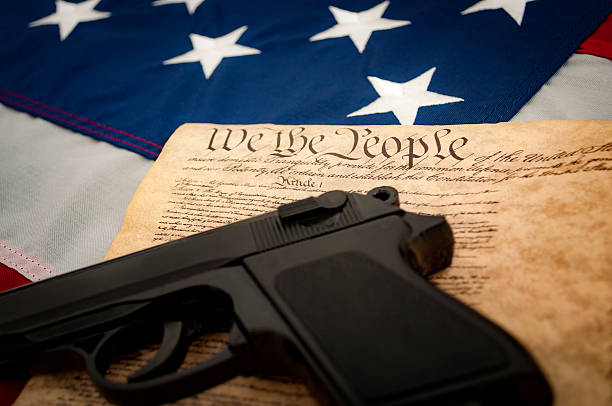 istock American Flag, a handgun and the US constitution 539357224