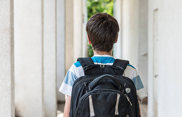Teenage school boy with a backpack walking to school Teenage school boy with a backpack walking to school ass boy stock pictures, royalty-free photos & images