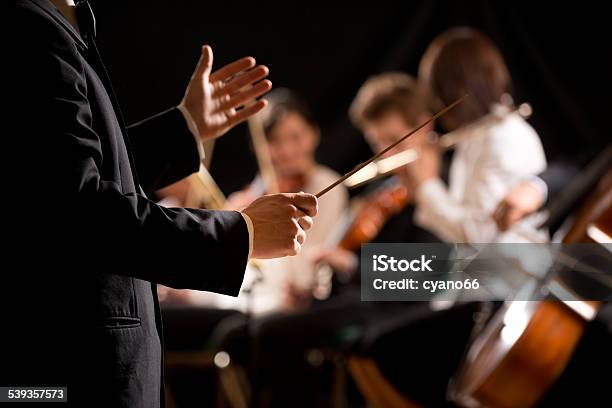 Orchestra Conductor On Stage Stock Photo - Download Image Now - Orchestra, Musical Conductor, Classical Music
