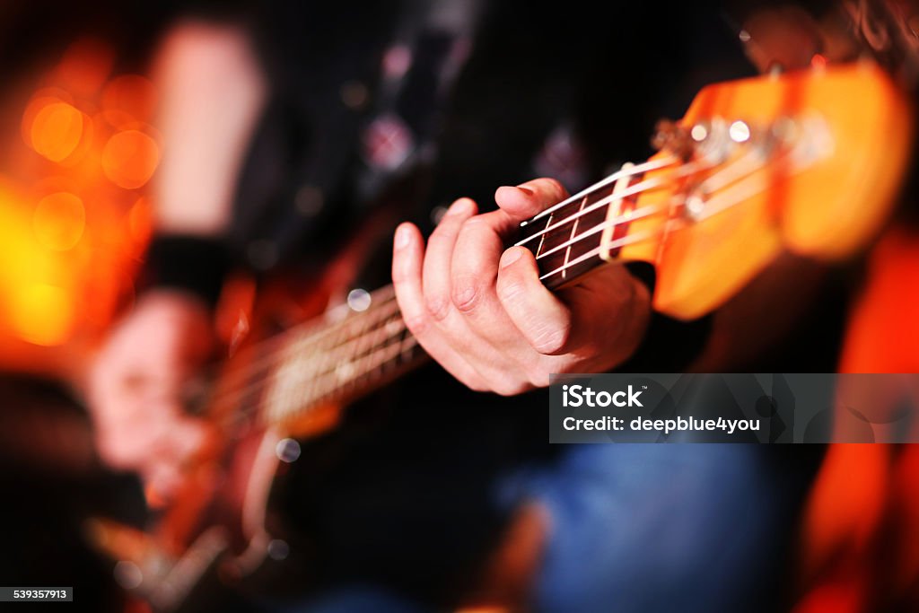 Playing electric bass guitar hand on bass guitar Bass Guitar Stock Photo