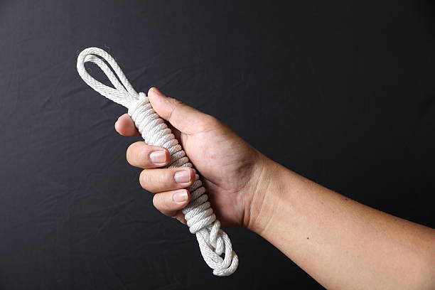 istock Rope in hand man isolated on black background 539358222