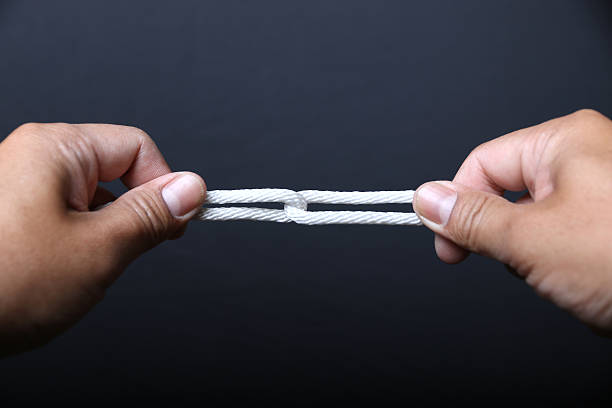 istock Hand holding a loop of rope for hanging. 539358290