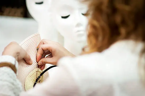 The milliner working in a hat with his own hands