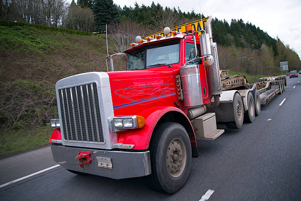 istock Big rig red semi truck with oversize flat bed 539358912