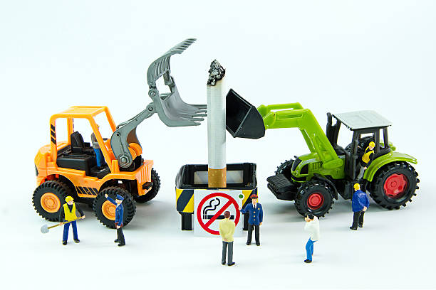 Tiny toys destroy cigarette.Concept No Smoking Day.