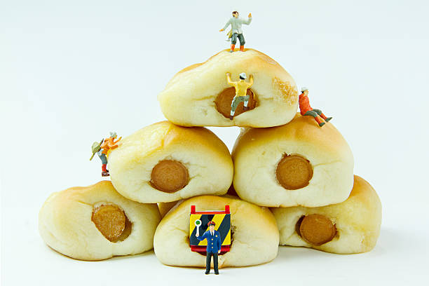 Tiny toys and Sausage bread.Concept food background.