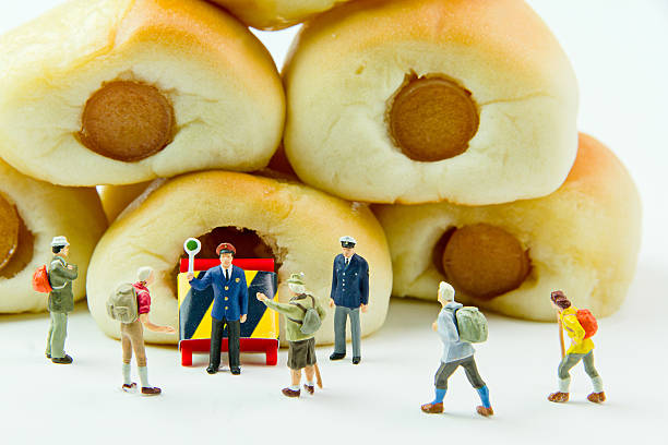 Tiny toys and Sausage bread.Concept food background.