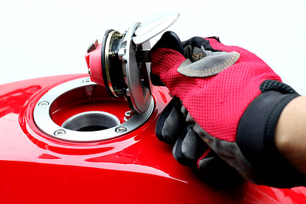 Men turn key motorcycle fuel tank.Men turn key motorcycle fuel tank.