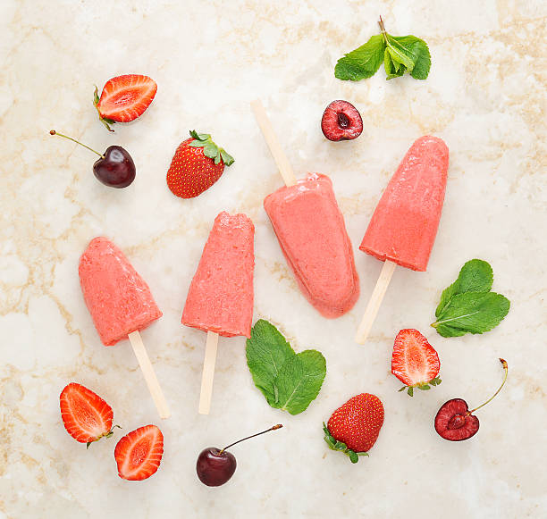 istock Strawberry yogurt ice cream popsicles with mint and cherry over 539361436