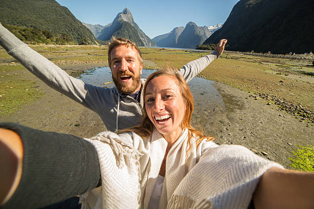 istock Cheerful couple takes selfie with mountain landscape 539362428