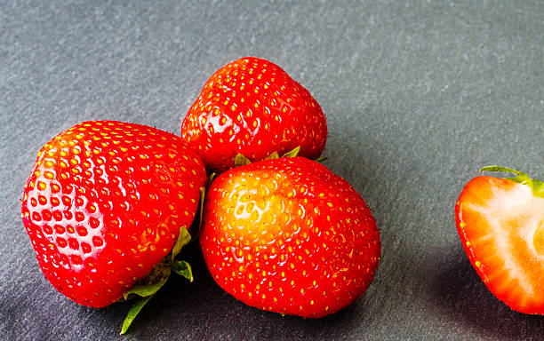 istock Red ripe strawberry on a dark background. 539362598