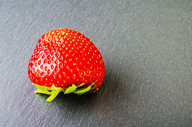 istock Red ripe strawberry on a dark background. 539362696