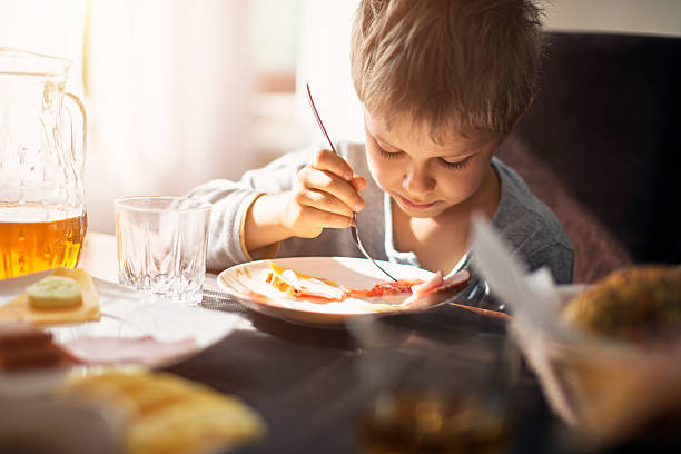 istock Little boy eating breakfast on sunny morning 539363392