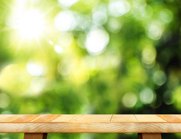 istock Empty wooden table and blurred garden bokeh light background 539364206