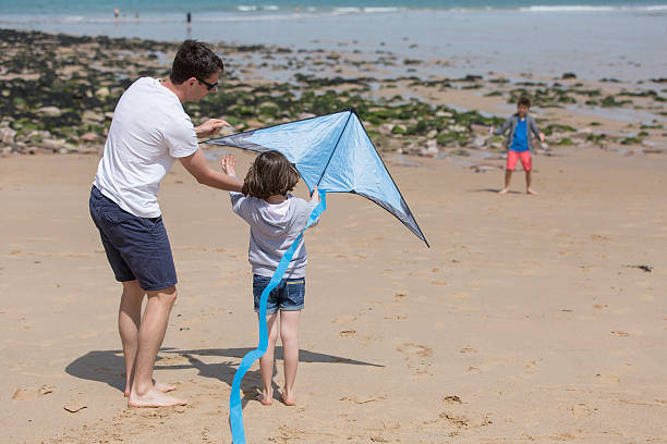 istock Family playing with kite 539365622