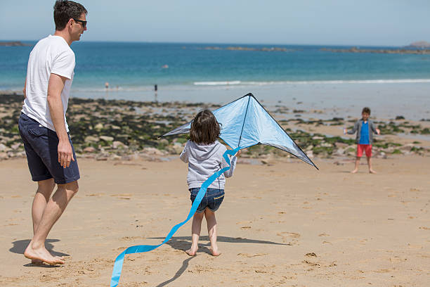 istock Family playing with kite 539365726