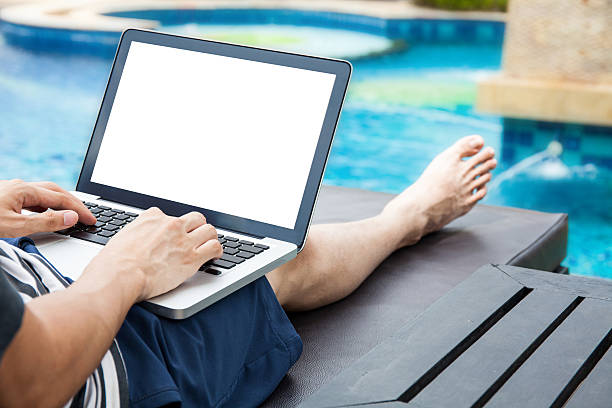 Screen mockup of laptop man using in pool on vacation