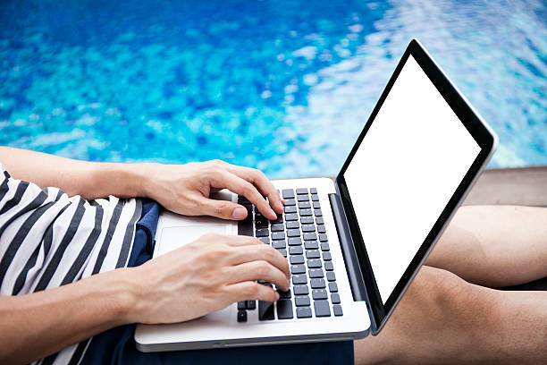 istock Screen mockup of laptop man using in pool on vacation 539366142