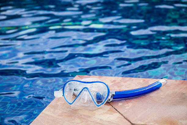 istock Snorkel mask laying beside the pool with copy space 539367076