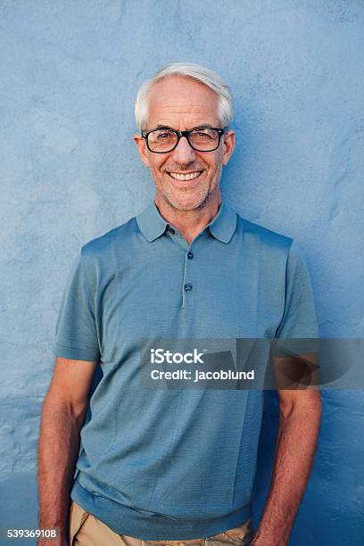 Handsome Mature Man Smiling At Camera Stock Photo - Download Image Now - Mature Men, Portrait, Colored Background