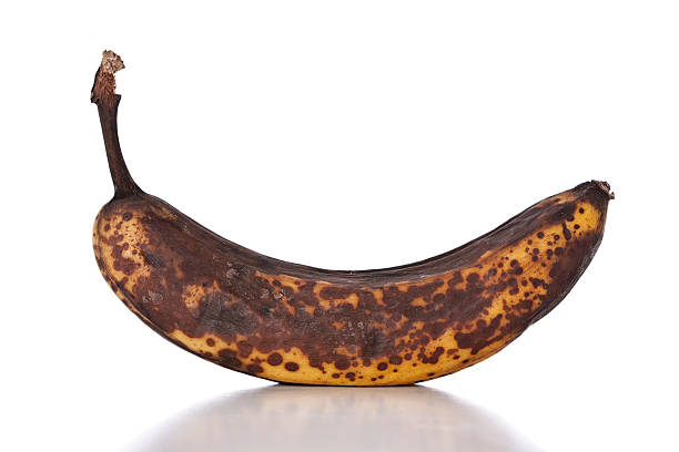 Rotten Banana A rotting banana isolated on white with shadow. bruised fruit stock pictures, royalty-free photos & images