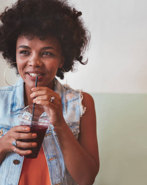 istock Young african woman drinking fresh fruit juice 539370338