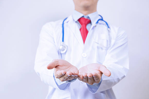 istock Doctor having product presentation gesture in white background 539371074