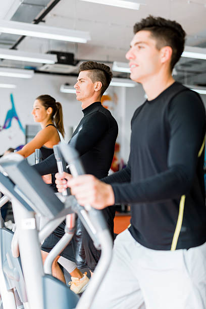 istock Young group of people working out on a elliptic trainer 539371520