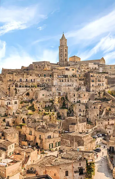 panoramic view of typical stones (Sassi di Matera) and church of Matera UNESCO European Capital of Culture 2019 under blue sky. Basilicata, Italy