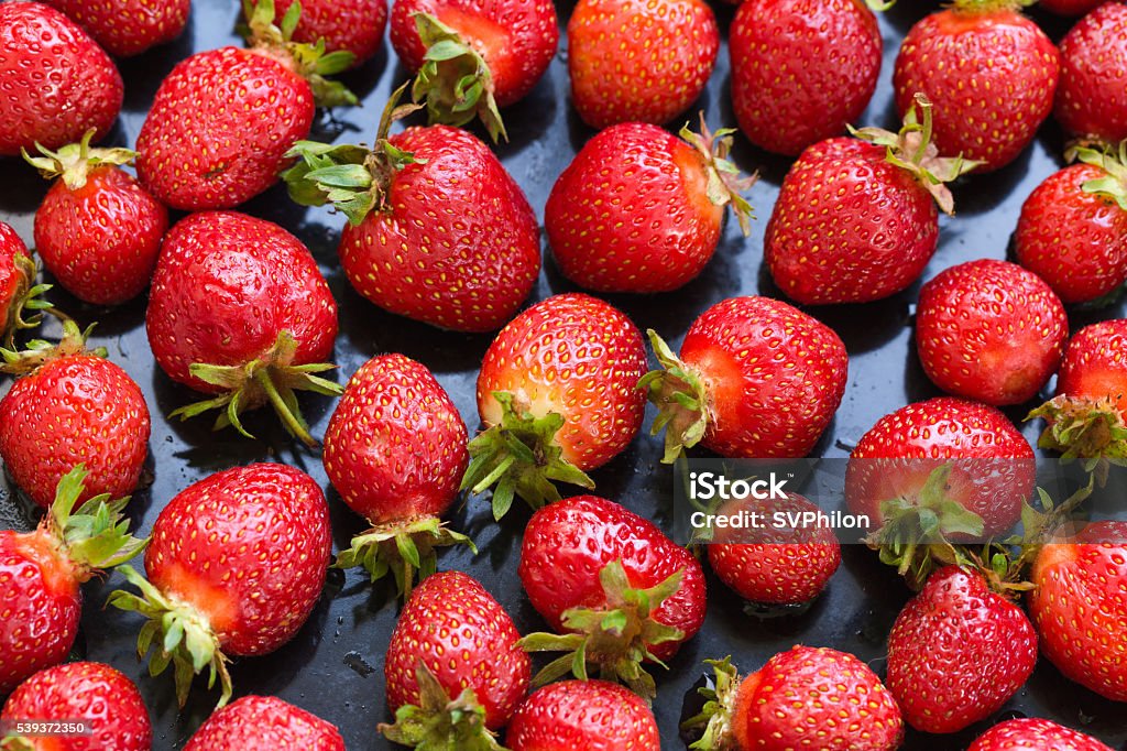 Fresh strawberries on black background. Fresh strawberries on black background. Top view. Agriculture Stock Photo