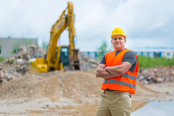 A confident construction worker poses with an adjustable wrench, fully prepared and ready to tackle various tasks ahead