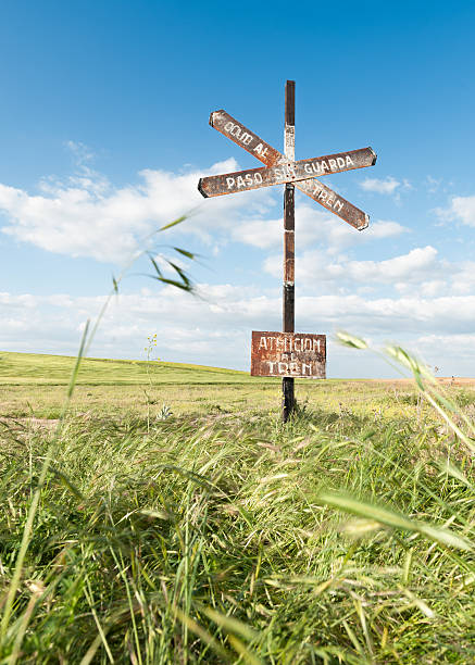 istock iron sign over blue sky background and green field 539373048