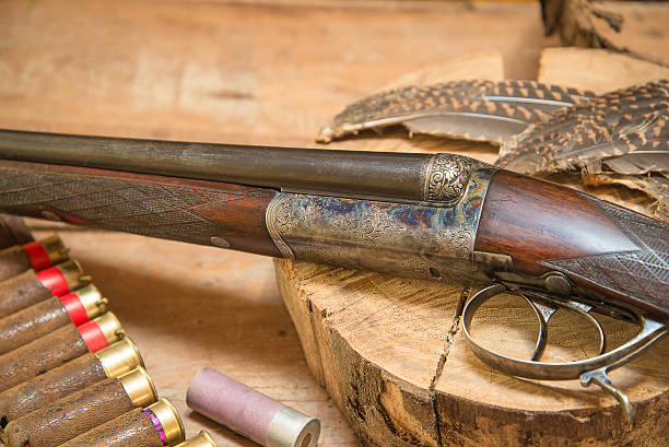 istock Hunting gun with hunting cartridges and feathers 539374108