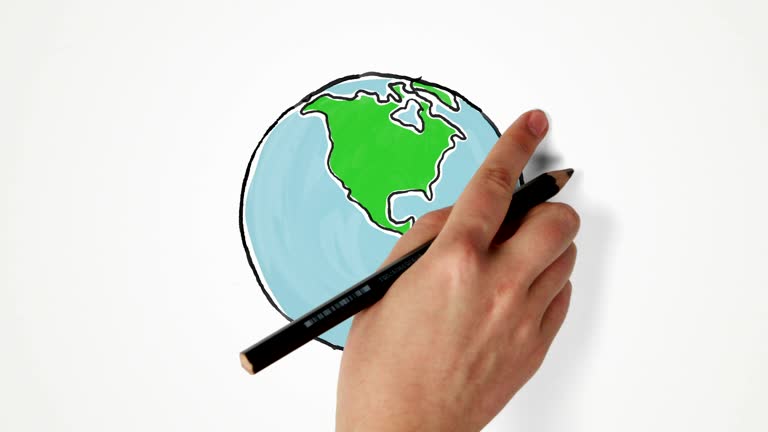 Hand draws and turns Earth globe