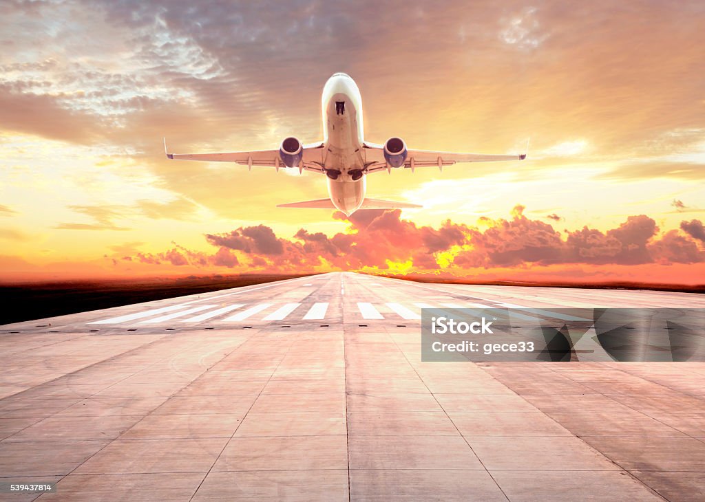 Passenger plane take off on sunset Airplane Stock Photo
