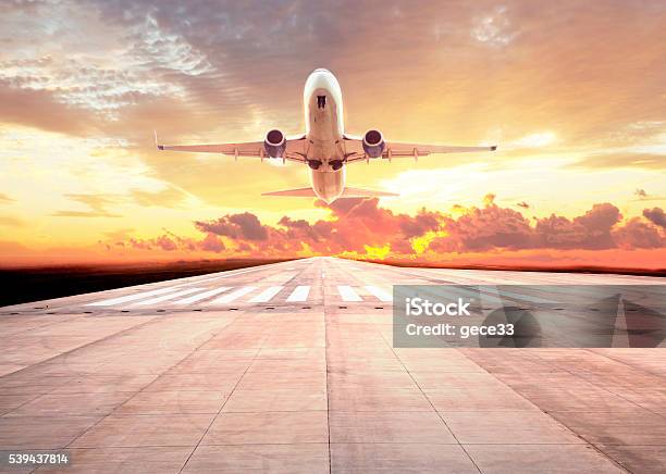 Passenger Plane Take Off On Sunset Stock Photo - Download Image Now - Airplane, Airport Runway, Taking Off - Activity