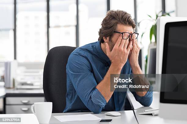 Stressed Young Businessman Stock Photo - Download Image Now - Emotional Stress, Working, Tired