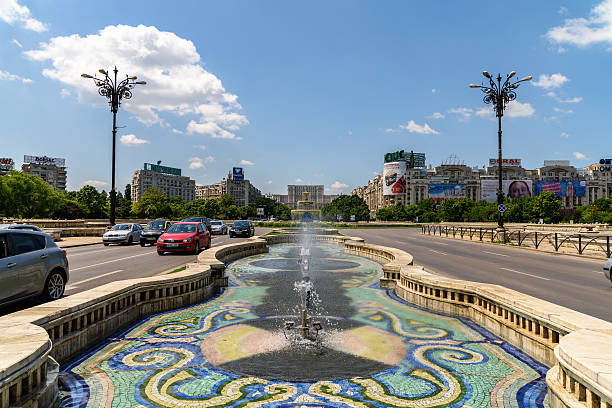 Union Square Fountain And Parliament Palace In Bucharest Bucharest, Romania - May 28, 2016: Union Square Fountain And House Of The People Or Parliament Palace (Casa Poporului) View From Union Boulevard (Bulevardul Unirii) In Downtown Bucharest. parliament palace in bucharest romania the largest building in europe stock pictures, royalty-free photos & images