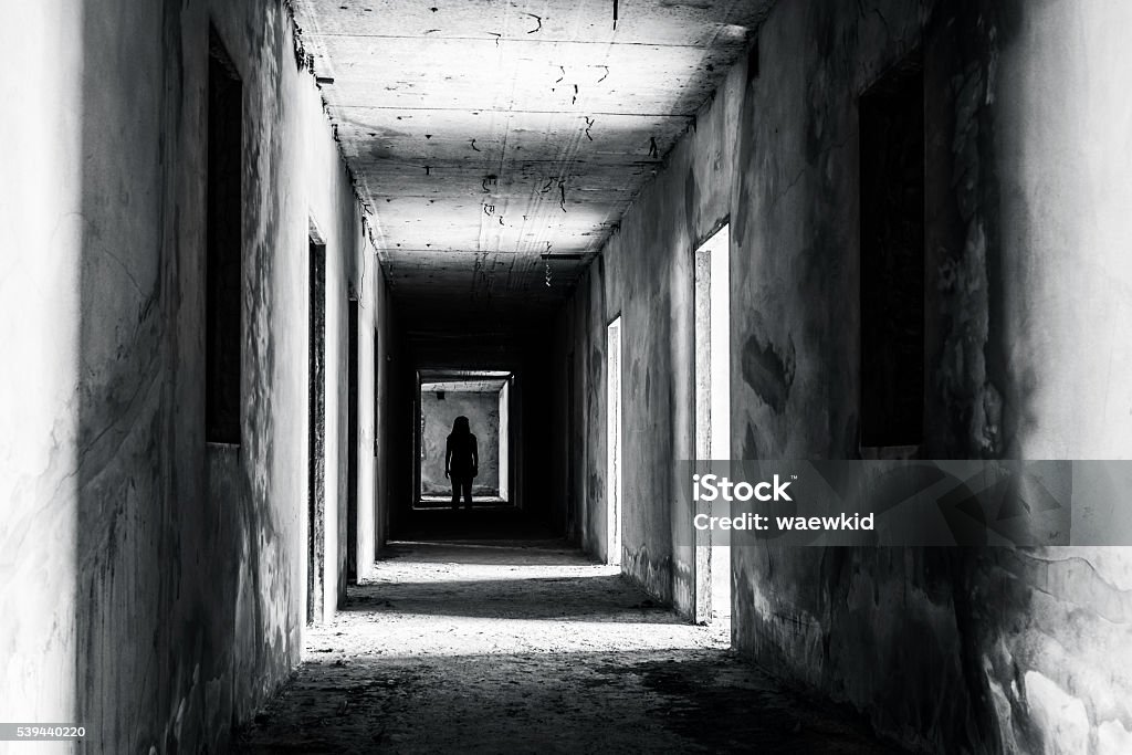 walkway in abandoned building with scary woman inside walkway in Abandoned building with scary woman inside, darkness horror and halloween background concept Spooky Stock Photo