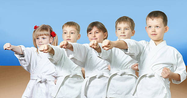 istock Kids in karategi are hitting punch arm 539441032