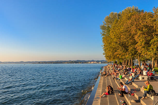 Bregenz, Promenade - Austria Bregenz, Austria - September 27, 2014: People enjoy the sunset on the promenade of Bregenz, located on the eastern shores of Lake Constance. The city is rich in prestigious buildings of ancient and contemporary architecture.  bregenz stock pictures, royalty-free photos & images