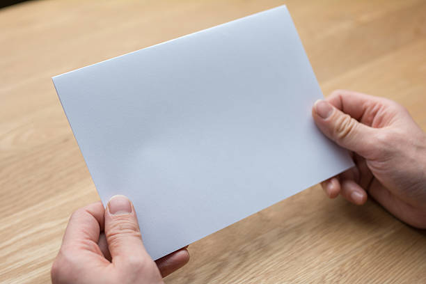 istock businessman holding white blank paper 539443058