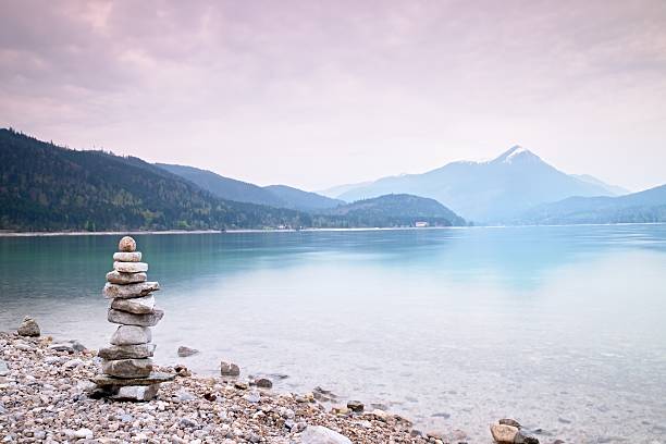 istock Children built pyramid from pebbles.  Rainy day. 539443168
