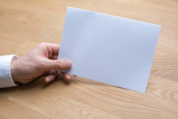istock businessman holding white blank paper 539443514