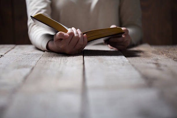 istock Woman hands praying with a bible 539444728