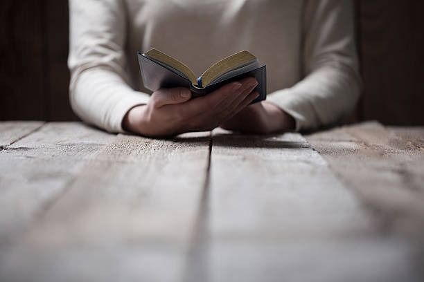 istock Woman hands praying with a bible 539444788