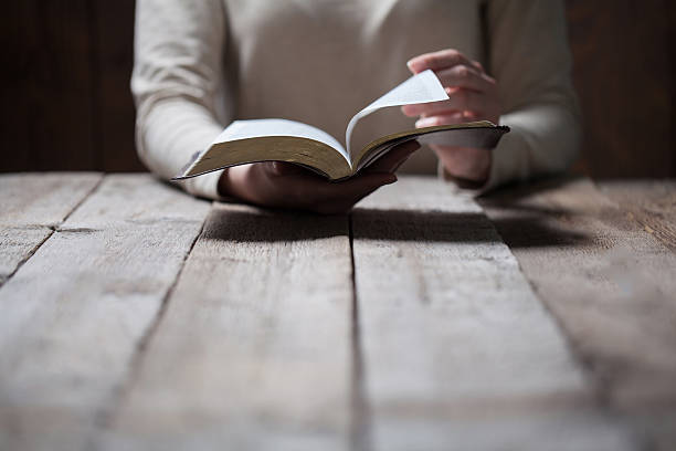 istock Woman hands praying with a bible 539444856
