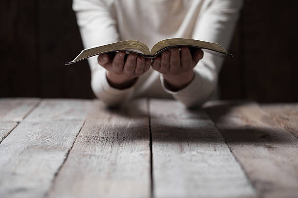 istock Woman hands praying with a bible 539444896